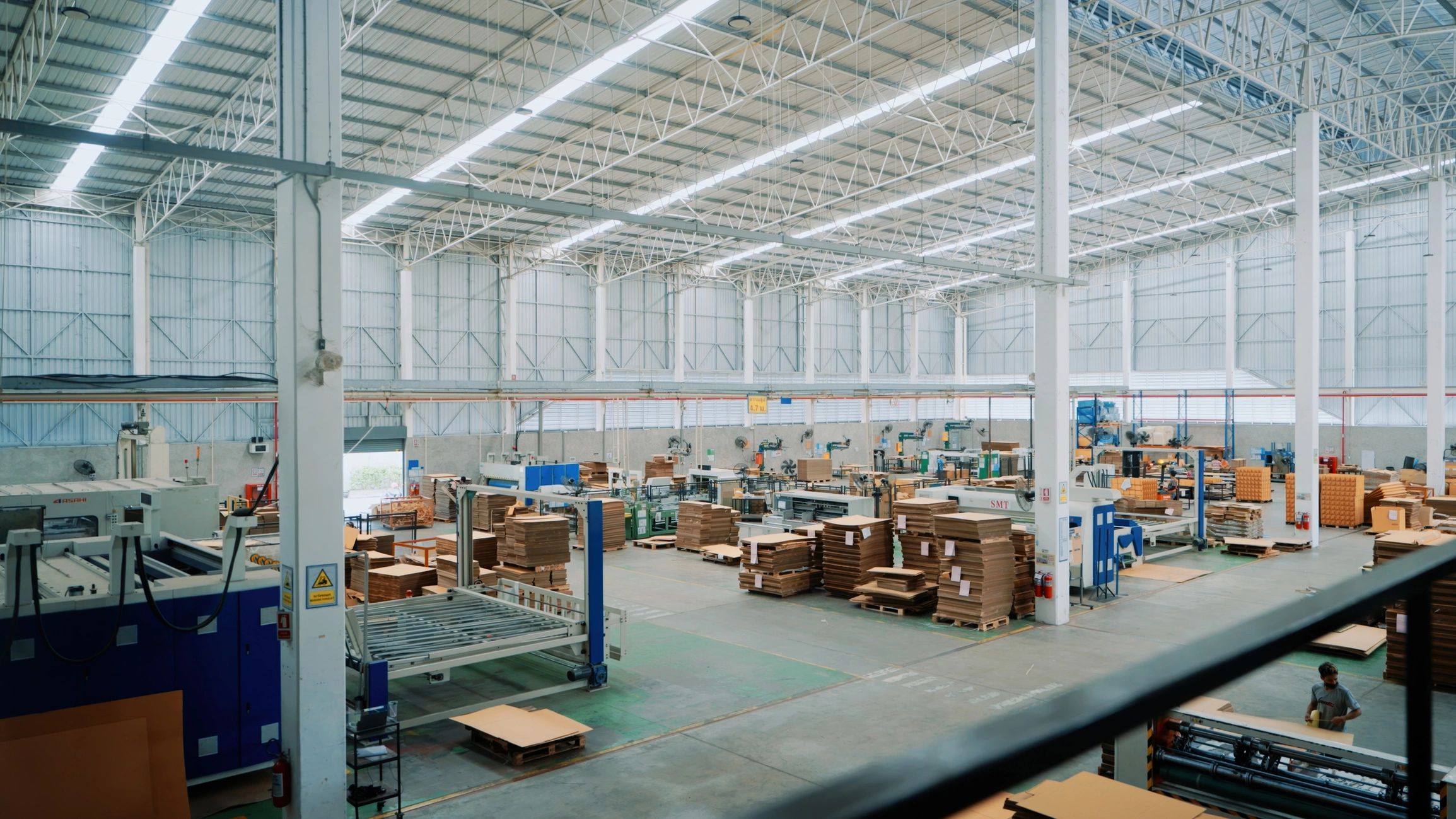 Modern factory floor and packaging area showing organized production and logistics